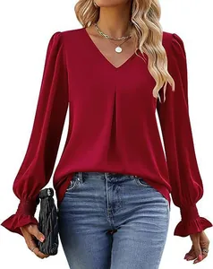 Close-up detail of wine red satin blouse featuring a V-neck and flared ruffles on cuffs