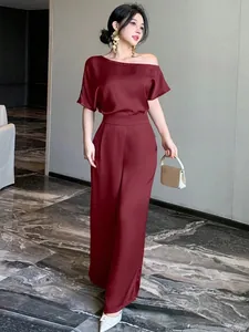 Elegant burgundy satin jumpsuit with an asymmetric shoulder and wide-leg design