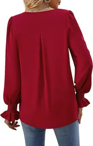Back view of elegant burgundy satin blouse with pleated back and flared ruffled cuffs