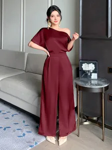 Elegant wine red satin jumpsuit featuring asymmetrical one-shoulder design and a smooth finish