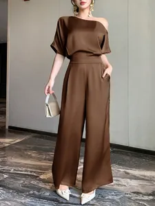 Elegant brown satin asymmetrical jumpsuit featuring a stylish off-the-shoulder design