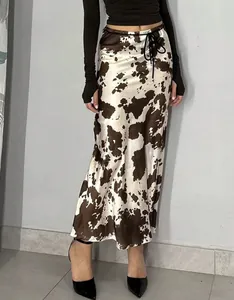 Detail view of the satin cow print midi skirt featuring a smooth texture and a flattering fit.