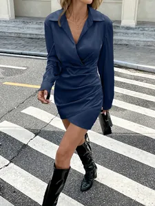 Elegant navy blue satin long sleeve mini dress featuring a ruched waist and wrap V-neck