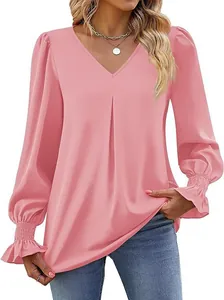 Detail of elegant pink satin blouse featuring V-neck and smocked ruffled sleeve cuffs