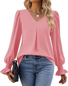 Detailed view of pink satin V-neck blouse featuring ruffled cuffs and lantern sleeves
