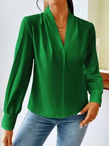 Detail view of the vibrant green satin blouse featuring a V-neck and pleated neckline