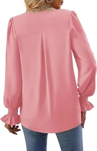 Detailed back view of a pink satin blouse featuring pleated design and ruffled cuffs