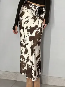 Elegant high-waisted satin long skirt featuring a stylish brown and white cow print pattern