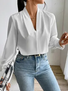 Detail view of an elegant white satin V-neck blouse showing smooth fabric texture.