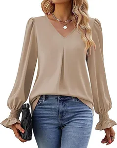 Detailed view of an elegant V-neck satin blouse with stylish flared cuffs and lantern sleeves.