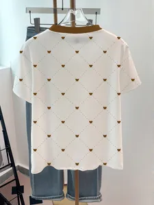 Back view of white round neck T-shirt with brown heart and dotted diamond pattern