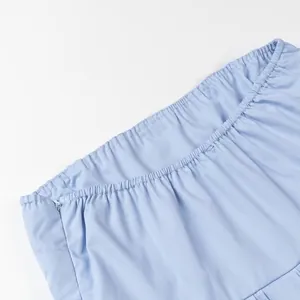 Close-up detail of light blue tube top with elasticated hem and hidden zipper.
