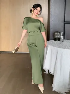 Elegant sage green satin jumpsuit featuring an asymmetric off-shoulder neckline and wide legs