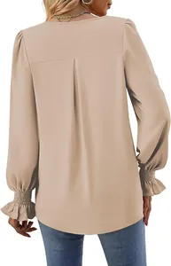 Back view detail of a beige satin blouse with pleated design and flare sleeves