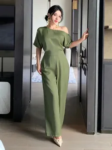 Detail of olive green satin jumpsuit featuring an elegant asymmetrical one-shoulder design.
