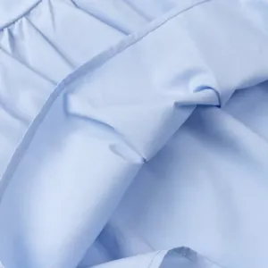 Close-up of light blue fabric detail on a fashionable versatile tube top