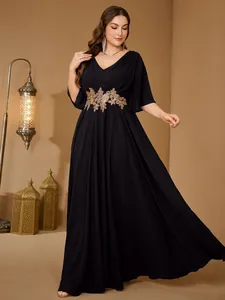 Elegant plus-size black maxi dress with gold waist embroidery and flutter sleeves