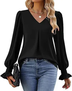 Detail showing elegant black satin blouse with V-neckline and lantern sleeve design