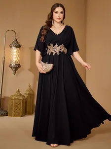 Elegant plus-size V-neck evening gown with flutter sleeves and gold embroidery.