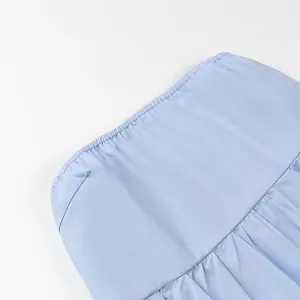 Close-up detail of light blue tube top with elasticated gathered neckline