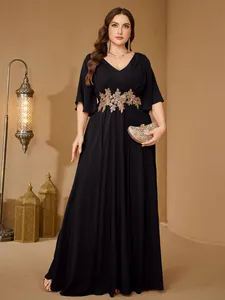 Elegant plus size black evening gown featuring intricate gold floral embroidery at the waist