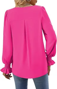 Detailed back view of a fuchsia satin blouse featuring pleated design and elegant ruffled cuffs