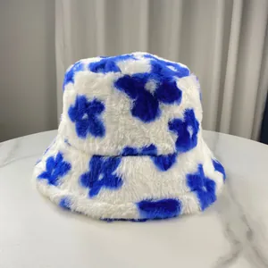 Detailed view of a soft plush bucket hat with vibrant blue floral pattern on white