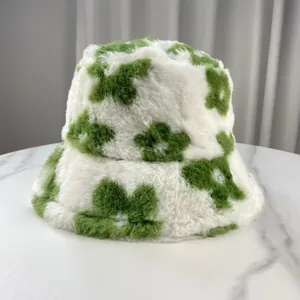 Detailed macro view of soft fuzzy faux fur bucket hat with vibrant green flower pattern