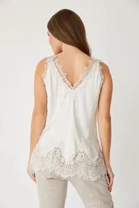 Detailed back view of an elegant white satin camisole featuring intricate floral lace trim