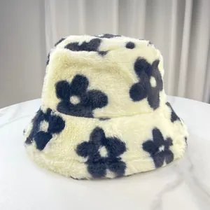 Detail view of a plush cream bucket hat with black floral pattern for winter warmth.