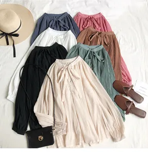 Detailed layout of pleated chiffon shirts in various colors with elegant tie-neck design