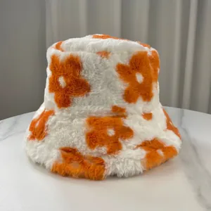 Detail view of winter plush floral bucket hat with soft white and orange fur.