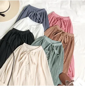 Macro view of vintage pleated chiffon blouses with tie-neck detail in multiple colors.