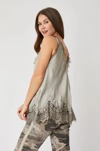 Detailed view of the elegant grey silk-like camisole with intricate lace hem.