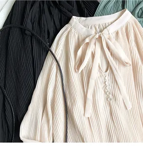 Detailed view of elegant pleated long sleeve chiffon blouse with bow tie V-neckline texture