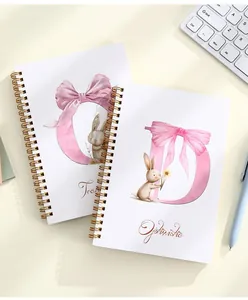 Detailed view of two A5 spiral notebooks with cute rabbit and bow design