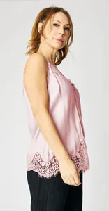 Elegant light pink silk-like camisole with intricate lace hem detailing for women.