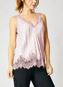 Detailed view of a pink V-neck camisole featuring exquisite floral lace trim on a model