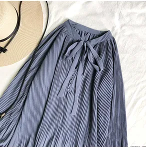 Close-up view of a blue pleated chiffon blouse featuring a V-neck tie bow detail.