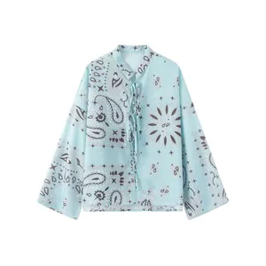 Detail view of light blue paisley print long sleeve blouse with lace-up neckline