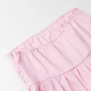Detail showing the elastic waistband and invisible side zipper of the pink tube top