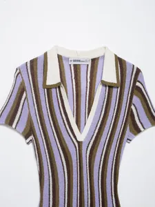 Detailed view of a striped knitted polo dress featuring a white V-neck and collar.