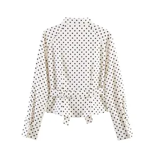 Detailed back view of a stylish white long sleeve blouse featuring a black polka dot pattern