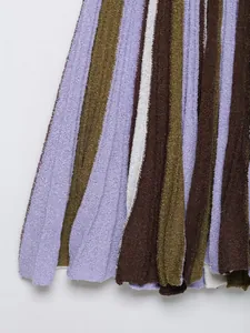 Detailed close-up of striped bouclé knit fabric in purple, green and brown tones