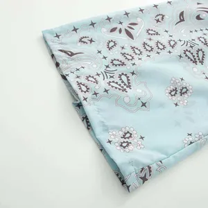 Close-up detail showing the intricate light blue paisley print fabric with neat stitching