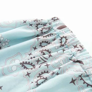 Close-up detail of light blue paisley print waistband with elastic gathering on soft fabric