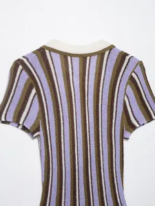 Detail view of a striped knit dress featuring purple, brown, and white vertical patterns.