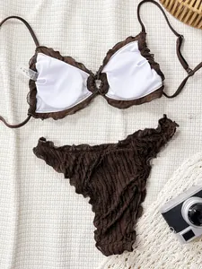 Close-up detail of a brown ruffled lace bikini set featuring a textured fabric and white lining