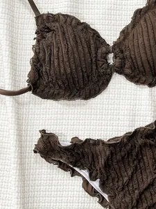 Detailed macro view showing the brown ruffled smocked fabric texture of this chic bikini set