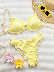 Detailed view of bright yellow seersucker bikini set with cute ruffle trim accents